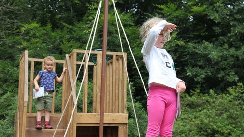 Children playing on wooden ship